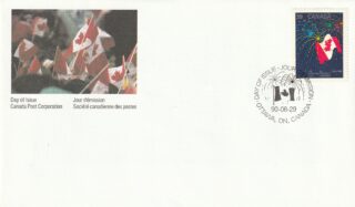 Canadian flags waving at a public event with a commemorative stamp.